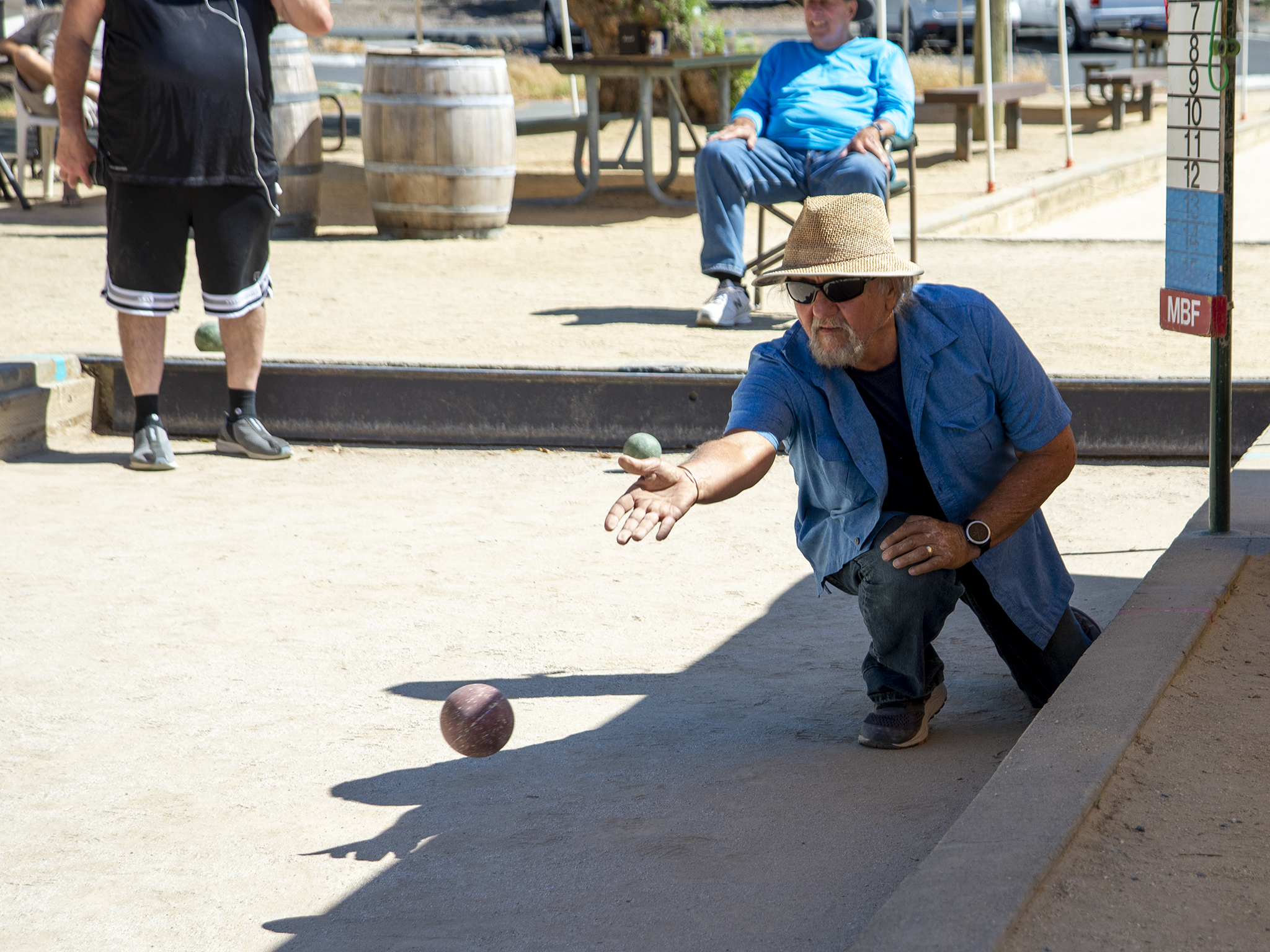 Bocce ball player rolling a bocce ball