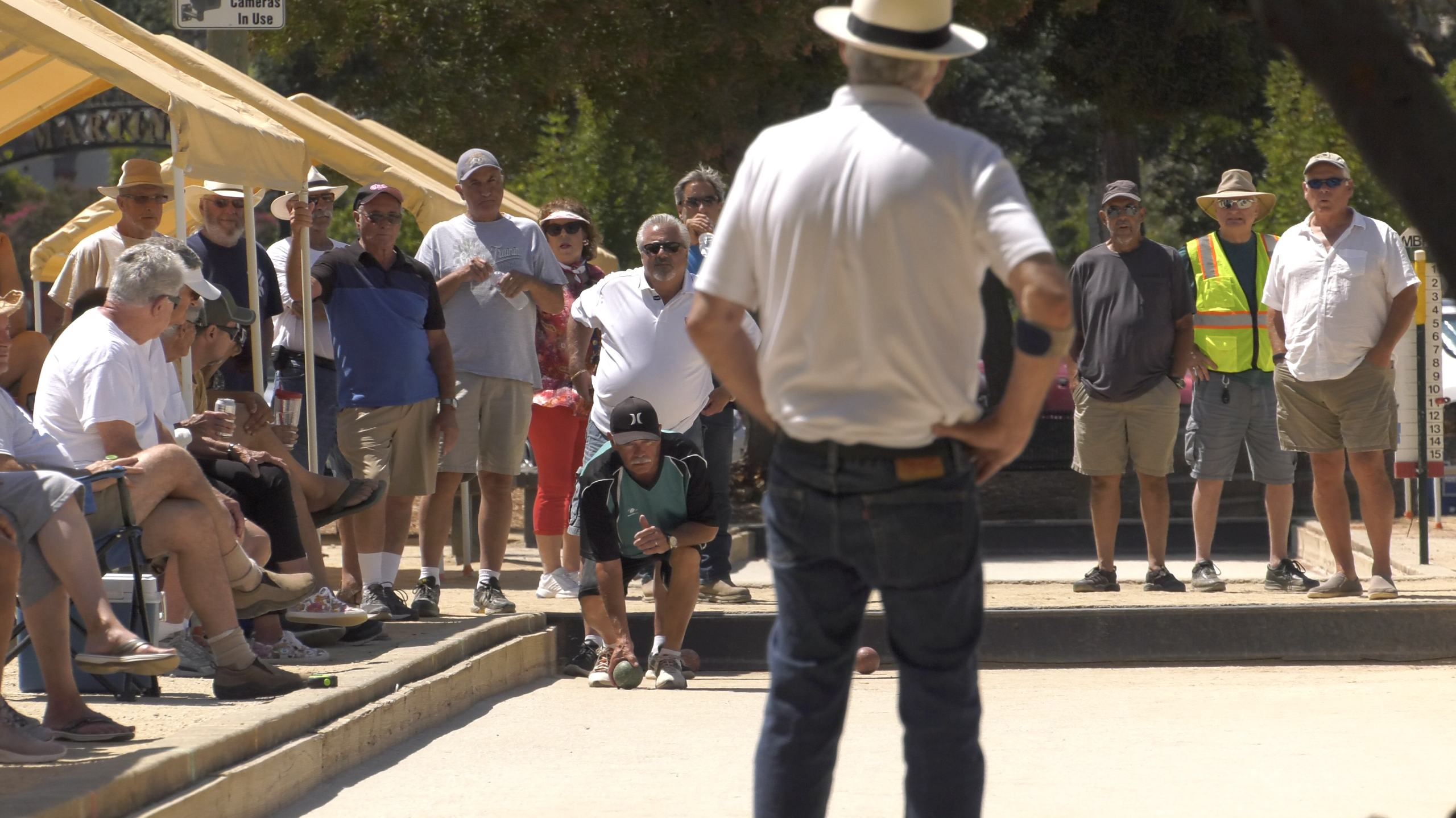 Bocce ball player rolling a bocce ball